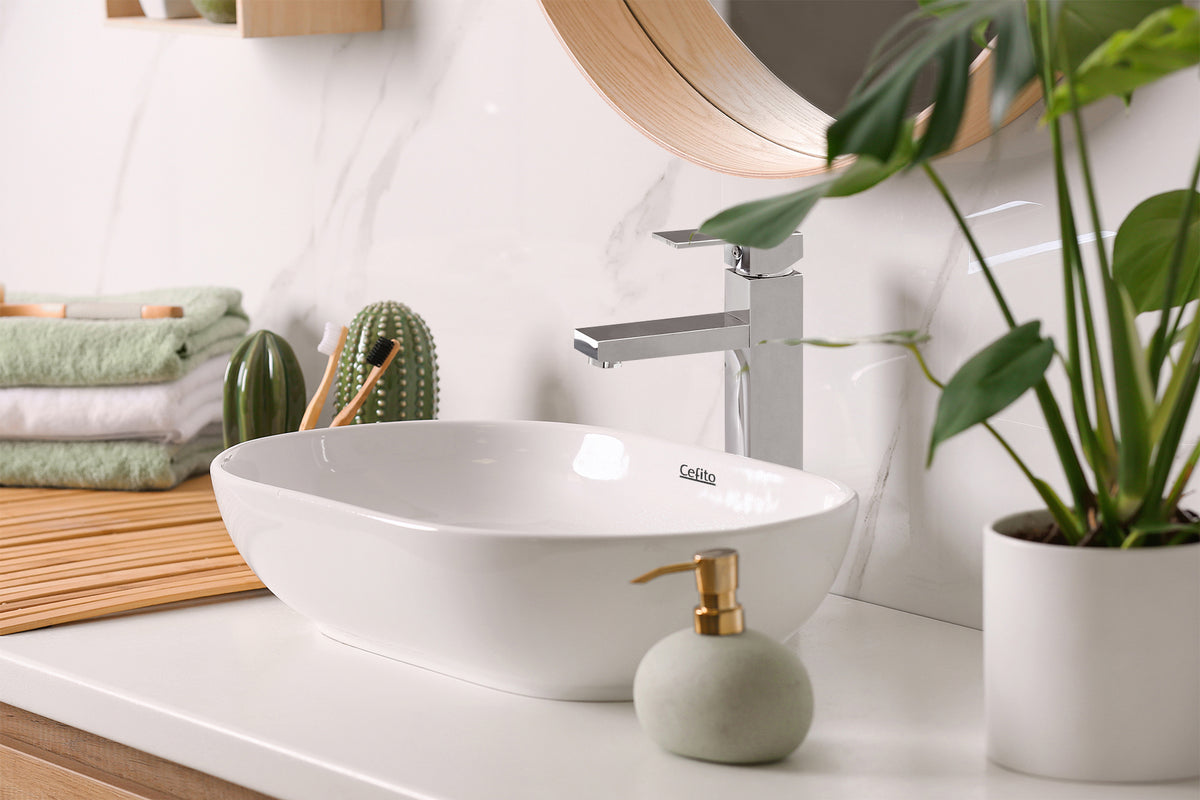 A white marble bathroom featuring a Cefito ceramic basin and silver tap.