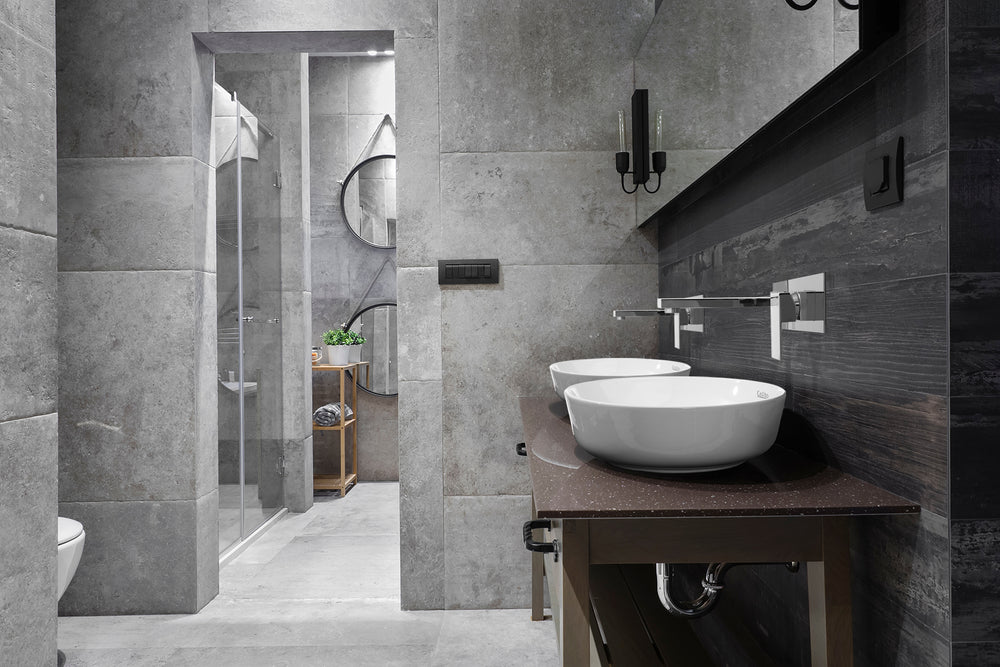 A granite tile bathroom featuring Cefito products including two white circular basins and two silver taps.